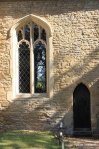 Biddenham, St James. Chancel, south window and priest's door.